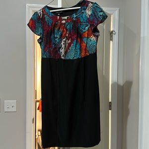 Sheath dress with coloring satin top and black bottom.